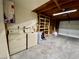 Spacious unfinished garage with laundry units and shelving offers ample room for storage and projects at 5215 Gray Ln, Las Vegas, NV 89119