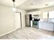 Bright kitchen featuring stainless steel appliances, white cabinets, and light wood-look flooring at 5215 Gray Ln, Las Vegas, NV 89119