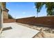 Backyard featuring a new concrete patio and a brick wall at 5824 Gemstone Peak St, North Las Vegas, NV 89031
