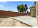 A large backyard with a new concrete patio and a brick fence at 5824 Gemstone Peak St, North Las Vegas, NV 89031