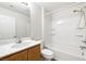 Bathroom featuring a single vanity, toilet, and shower-tub combo at 5824 Gemstone Peak St, North Las Vegas, NV 89031