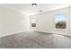 Bright bedroom with neutral walls, plush carpet, and two windows providing ample natural light at 5824 Gemstone Peak St, North Las Vegas, NV 89031