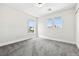 Bright bedroom with neutral walls, plush carpet, and three windows providing ample natural light at 5824 Gemstone Peak St, North Las Vegas, NV 89031