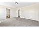 Neutral bedroom featuring carpeted floors, natural light, and doors to a bathroom and closet at 5824 Gemstone Peak St, North Las Vegas, NV 89031