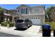 Inviting two-story home with a two-car garage and a beautifully landscaped front yard at 5824 Gemstone Peak St, North Las Vegas, NV 89031