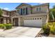 Charming two-story home featuring an attached two car garage and driveway at 5824 Gemstone Peak St, North Las Vegas, NV 89031