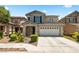 Charming two-story home featuring a well-maintained front yard and attached two car garage in a suburban community at 5824 Gemstone Peak St, North Las Vegas, NV 89031