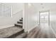 Bright hallway with staircase, hardwood floors and view to the living room with multiple windows at 5824 Gemstone Peak St, North Las Vegas, NV 89031