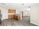 Kitchen and living room featuring stainless steel appliances, wood cabinets and hardwood floors at 5824 Gemstone Peak St, North Las Vegas, NV 89031