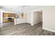 Open concept kitchen and living room with hardwood floors and modern fixtures at 5824 Gemstone Peak St, North Las Vegas, NV 89031