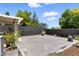 Low-maintenance backyard featuring gravel landscaping, potted plants, and a modern block wall for privacy at 620 Painted Cloud Pl, Las Vegas, NV 89144