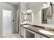 Bathroom featuring double sinks, granite counters, and access to walk-in closet at 620 Painted Cloud Pl, Las Vegas, NV 89144