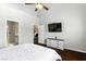 Spacious bedroom with a tv and ceiling fan at 620 Painted Cloud Pl, Las Vegas, NV 89144
