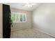 Spare bedroom with a ceiling fan, carpet, and window with plantation shutters at 620 Painted Cloud Pl, Las Vegas, NV 89144