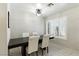 Bright dining area with large window, modern light fixture and seating for four at 620 Painted Cloud Pl, Las Vegas, NV 89144