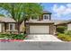 Inviting two-story home with a two-car garage, mature tree, and well-maintained landscaping at 620 Painted Cloud Pl, Las Vegas, NV 89144