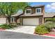 Inviting two-story home with a two-car garage, mature tree, and well-maintained landscaping at 620 Painted Cloud Pl, Las Vegas, NV 89144