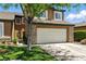 Charming home with a two-car garage, stone accents, and well-maintained front yard landscaping at 620 Painted Cloud Pl, Las Vegas, NV 89144