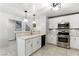 Modern kitchen featuring white cabinets, stainless steel appliances, and stone countertops at 620 Painted Cloud Pl, Las Vegas, NV 89144