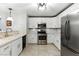 Modern kitchen featuring white cabinets, stainless steel appliances, and stone countertops at 620 Painted Cloud Pl, Las Vegas, NV 89144