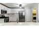 Well-lit kitchen featuring white cabinets, stainless steel appliances, and modern backsplash at 620 Painted Cloud Pl, Las Vegas, NV 89144
