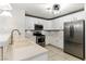 Modern kitchen featuring white cabinets, stainless steel appliances, and stone countertops at 620 Painted Cloud Pl, Las Vegas, NV 89144