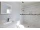 Renovated bathroom featuring white marble tile shower and modern vanity at 6317 Alta Dr, Las Vegas, NV 89107