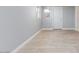 Bedroom with tile floors, natural light, and an entry door at 6317 Alta Dr, Las Vegas, NV 89107