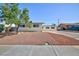 Single story home boasts a spacious front yard with gravel and a lush green tree at 6317 Alta Dr, Las Vegas, NV 89107