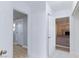 Bright hallway featuring white walls and tile flooring, leading to other rooms in the home at 6317 Alta Dr, Las Vegas, NV 89107