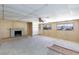 Cozy living room with wood paneling, a brick fireplace, and large windows at 6317 Alta Dr, Las Vegas, NV 89107