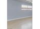 Bright living room with light gray walls and lovely laminate wood flooring at 6317 Alta Dr, Las Vegas, NV 89107