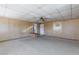 Spacious living room with neutral carpeting, wood paneling, and ceiling fan at 6317 Alta Dr, Las Vegas, NV 89107