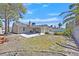 Backyard with patio, pool, sparse grass, block wall, and palm trees at 7113 Carrondale Way, Las Vegas, NV 89128