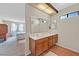 Bathroom featuring a double vanity and entry into an adjacent bedroom at 7113 Carrondale Way, Las Vegas, NV 89128