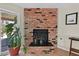 Close-up of brick fireplace with decorative plant in living area at 7113 Carrondale Way, Las Vegas, NV 89128