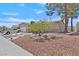 Inviting front yard with mature landscaping and a well-maintained exterior at 7113 Carrondale Way, Las Vegas, NV 89128