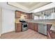 Traditional kitchen featuring stainless steel appliances, wood cabinets, and lots of natural light at 7113 Carrondale Way, Las Vegas, NV 89128