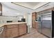 Spacious kitchen featuring stainless steel appliances, wood cabinets, and a view into the dining and living areas at 7113 Carrondale Way, Las Vegas, NV 89128