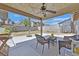 Covered patio space featuring outdoor seating beneath a ceiling fan, perfect for relaxing at 7113 Carrondale Way, Las Vegas, NV 89128