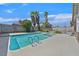 Backyard featuring a swimming pool, hot tub and three palm trees at 7113 Carrondale Way, Las Vegas, NV 89128