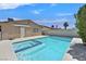 Backyard features a refreshing pool with integrated spa and stucco fencing for added privacy at 7113 Carrondale Way, Las Vegas, NV 89128