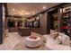 Spacious walk-in closet with custom shelving, mirrored cabinets, and a seating area at 720 Dragon Peak Dr, Henderson, NV 89012