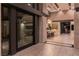 Modern foyer featuring stone accents, a glimpse of the bar area, and a game room, creating a welcoming atmosphere at 720 Dragon Peak Dr, Henderson, NV 89012