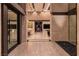Elegant foyer with stone accents, a glimpse of a game room, and a bar area, creating a welcoming ambiance at 720 Dragon Peak Dr, Henderson, NV 89012