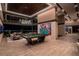 Open game room with a modern pool table, lounge area, and expansive windows with a city view at 720 Dragon Peak Dr, Henderson, NV 89012