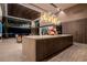 Kitchen island with modern lighting, wood cabinets, and sleek countertops in an open-concept design at 720 Dragon Peak Dr, Henderson, NV 89012