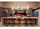 Modern kitchen with a large island, bar seating, and stainless steel appliances at 720 Dragon Peak Dr, Henderson, NV 89012