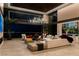 Luxurious living room featuring contemporary decor, ample seating, and breathtaking views of the Las Vegas skyline at 720 Dragon Peak Dr, Henderson, NV 89012