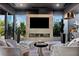 Comfortable living room with a modern fireplace, stone wall, and plush seating at 720 Dragon Peak Dr, Henderson, NV 89012